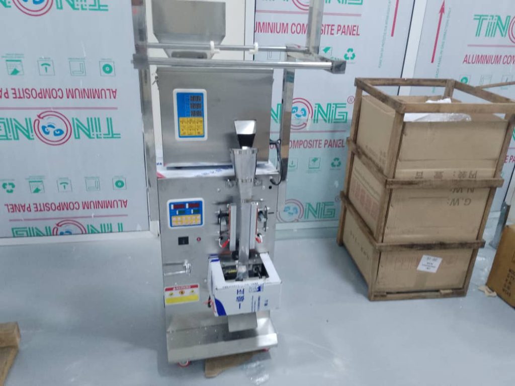 A stainless steel FZL-200 automatic granule packaging machine with dual control panels, suitable for packaging dry materials.